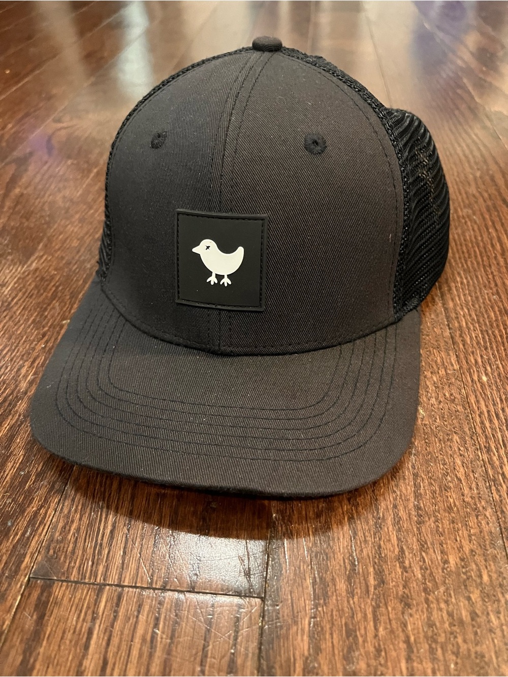 Bad Birdie Black Trucker Hat with White Bird Patch